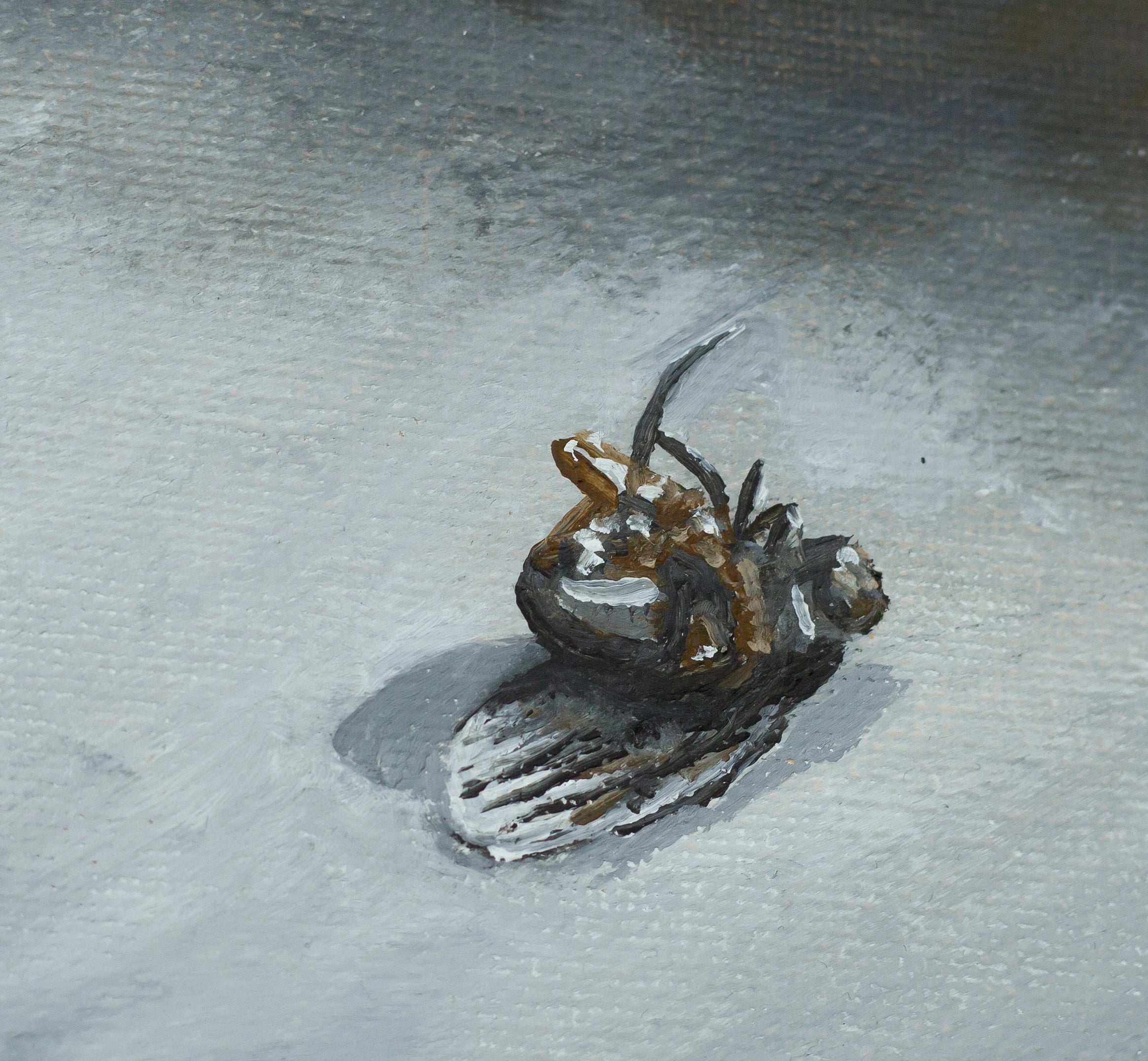 Close-up of the fly painting, showing the fly on its back with legs up and a soft shadow on grey canvas texture.
