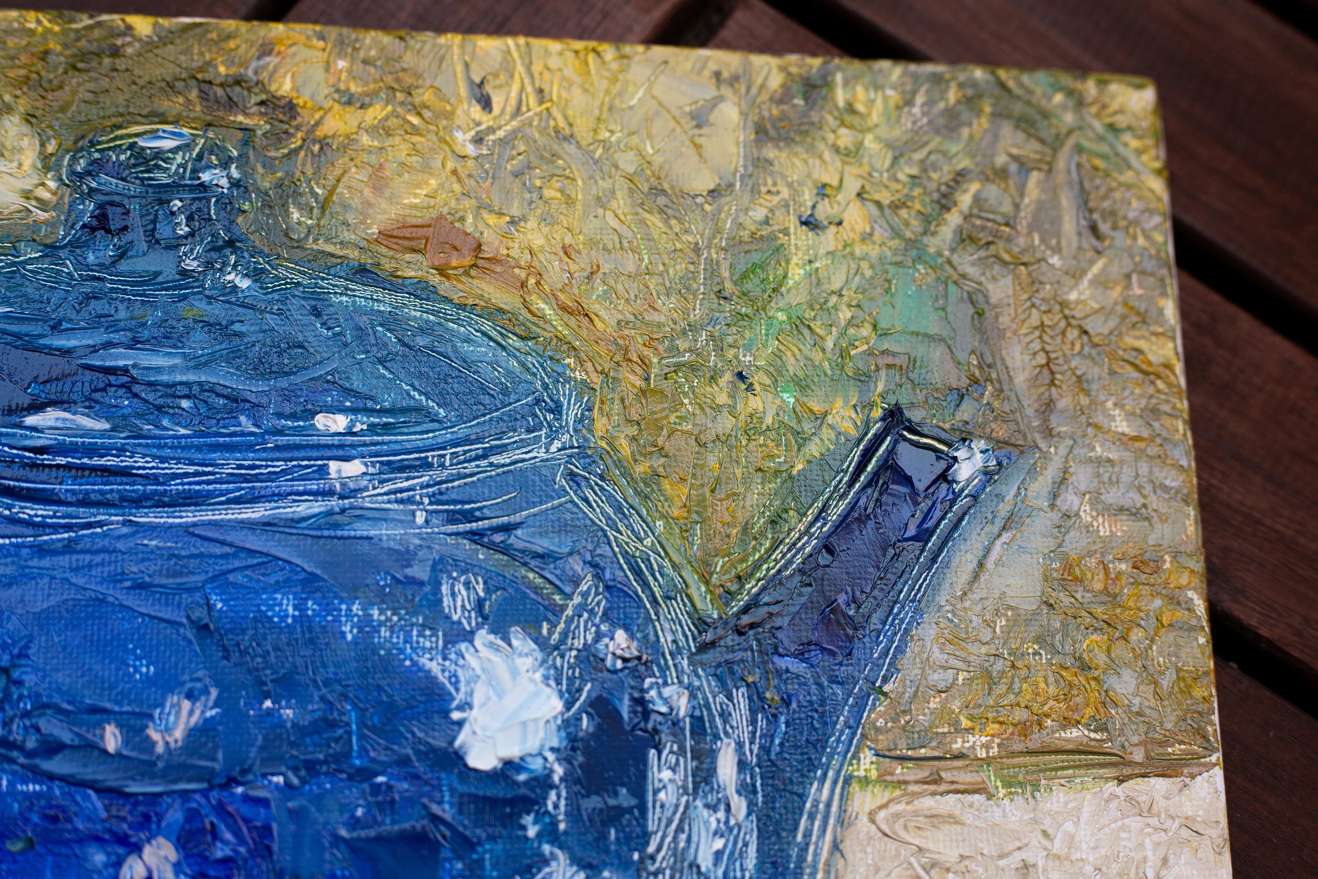 Close-up of thick blue impasto on the teapot's spout against the ochre and green background.