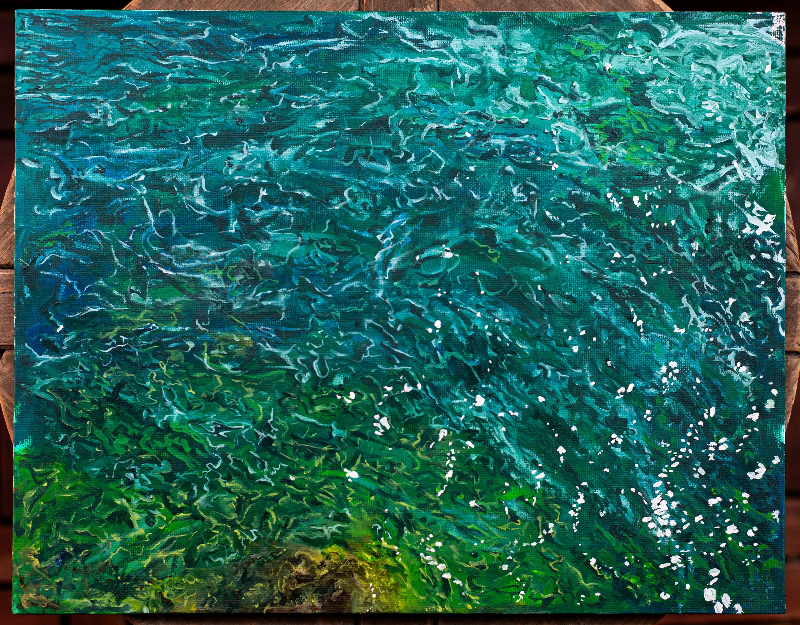 Water I photographed at an angle, showing raised teal and white strokes catching the light.