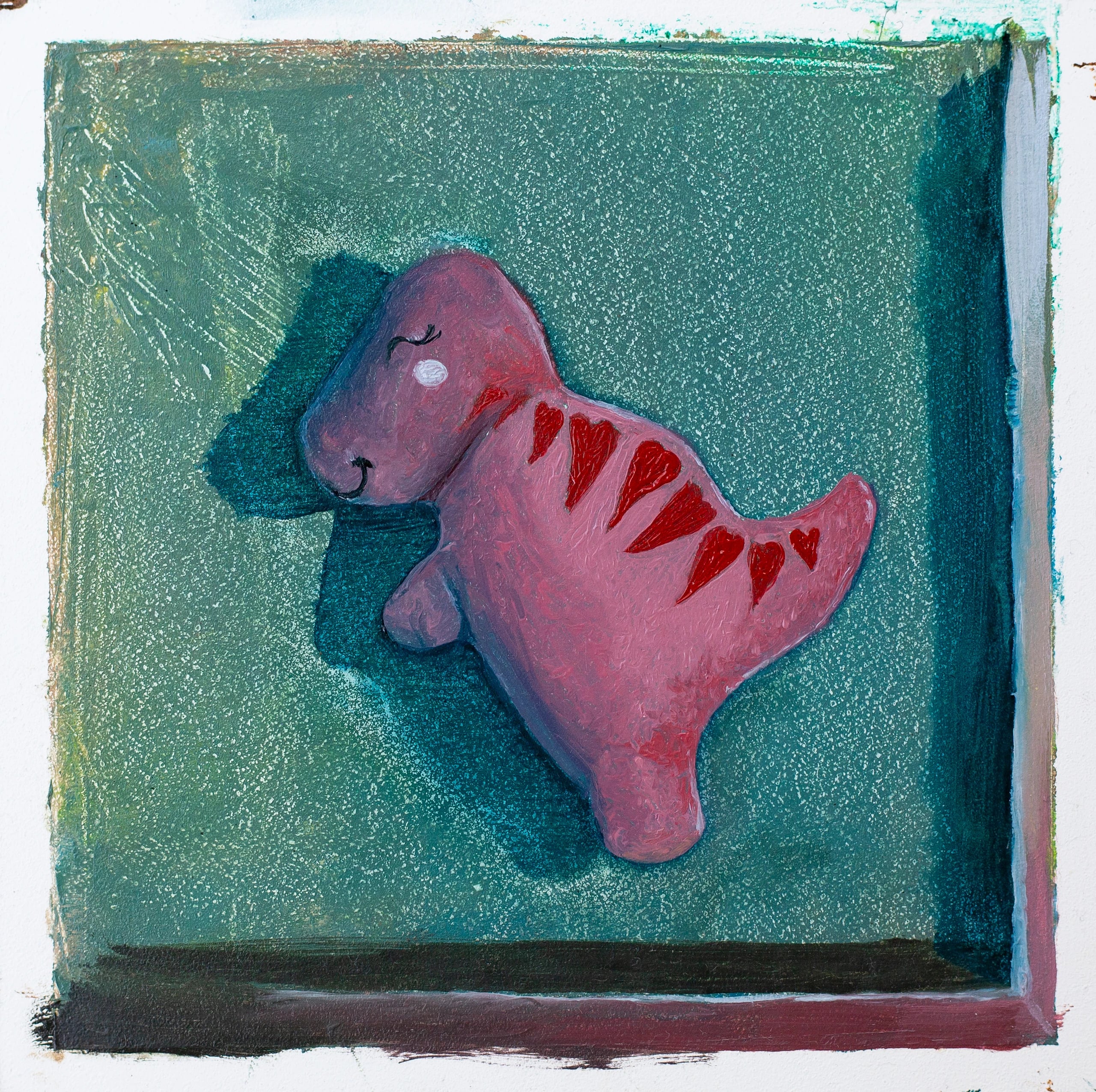 Oil painting of a pink toy dinosaur with red heart markings and a smiling face, lying in a teal box seen from above.