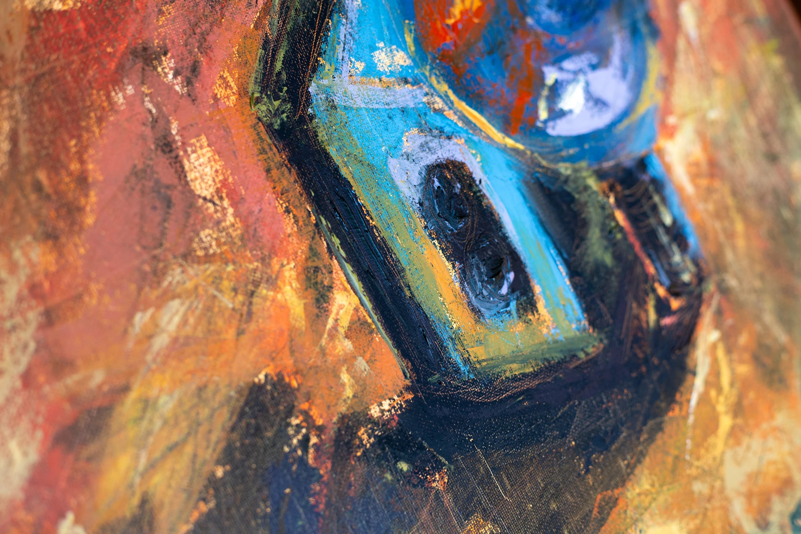 Close-up of the camera body's arched window shapes in blue and black against warm orange strokes.